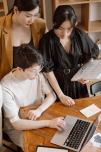 Focused team working together around a laptop during a business meeting.